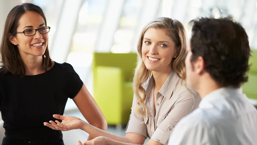 Group of people sitting around a table in arkansas discussing business insurance